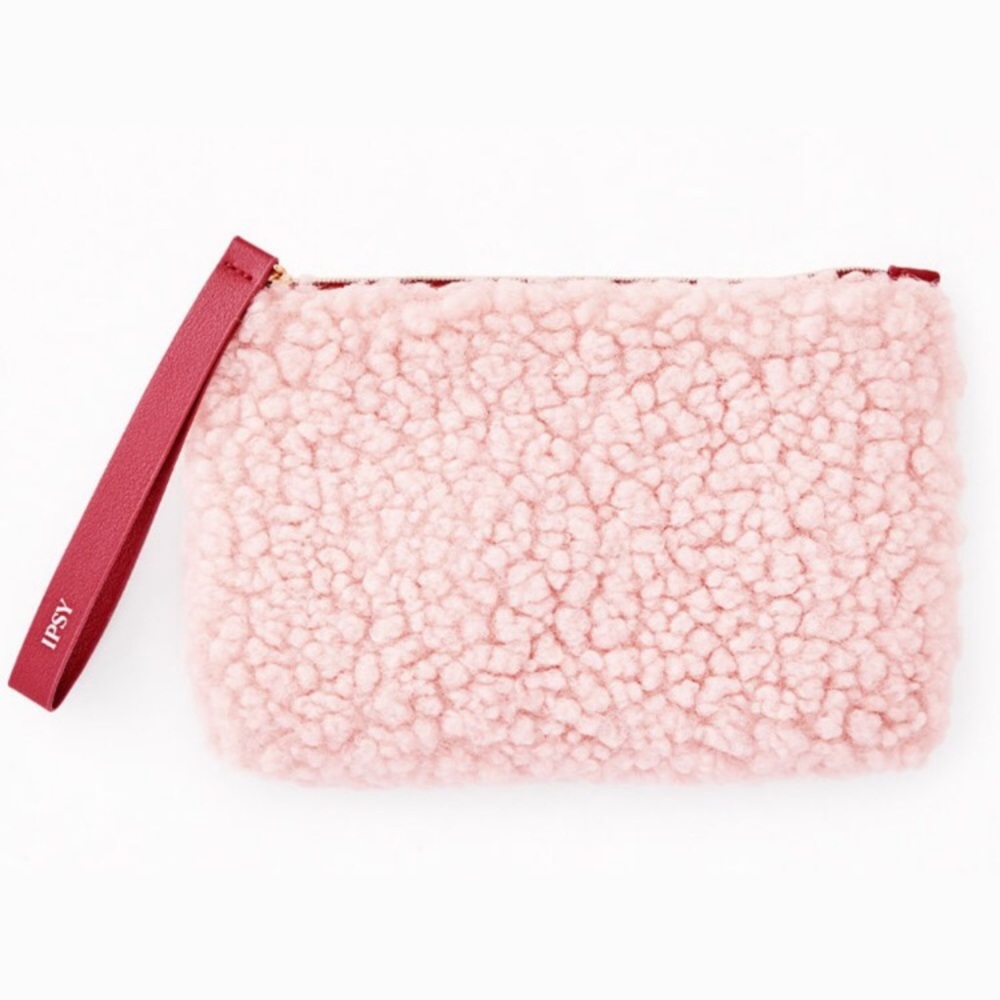 Fuzzy pink makeup bag with maroon zipper pull and inner lining